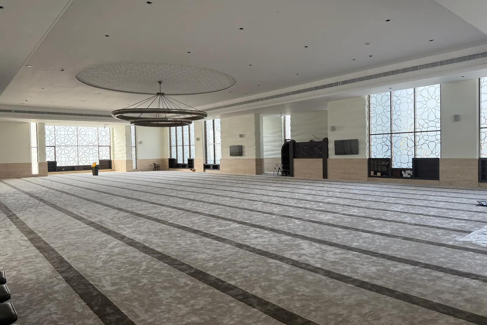 Wide view of the prayer hall with patterned window screens