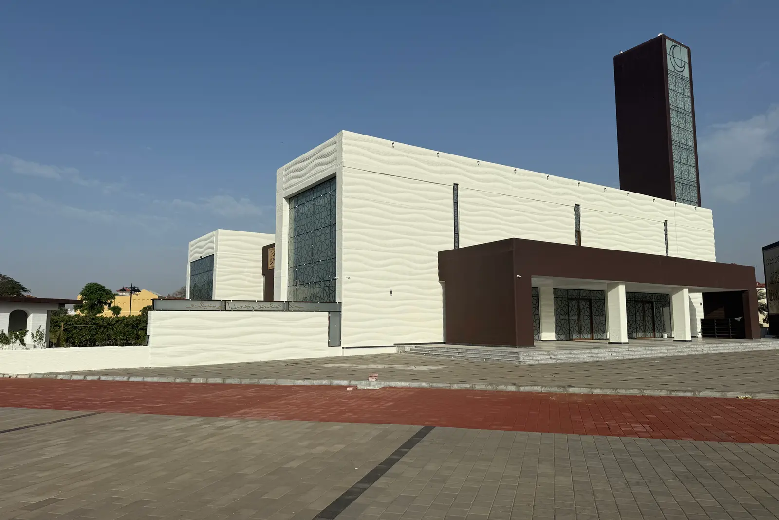 Side elevation with the minaret rising behind the printed walls