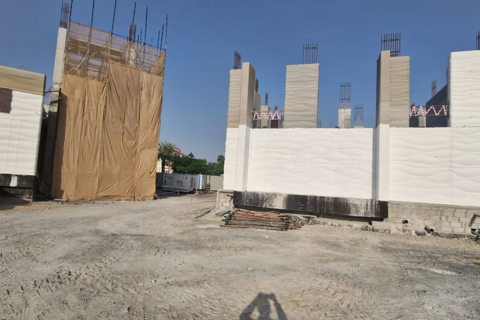 Printed wall panels standing on site during construction