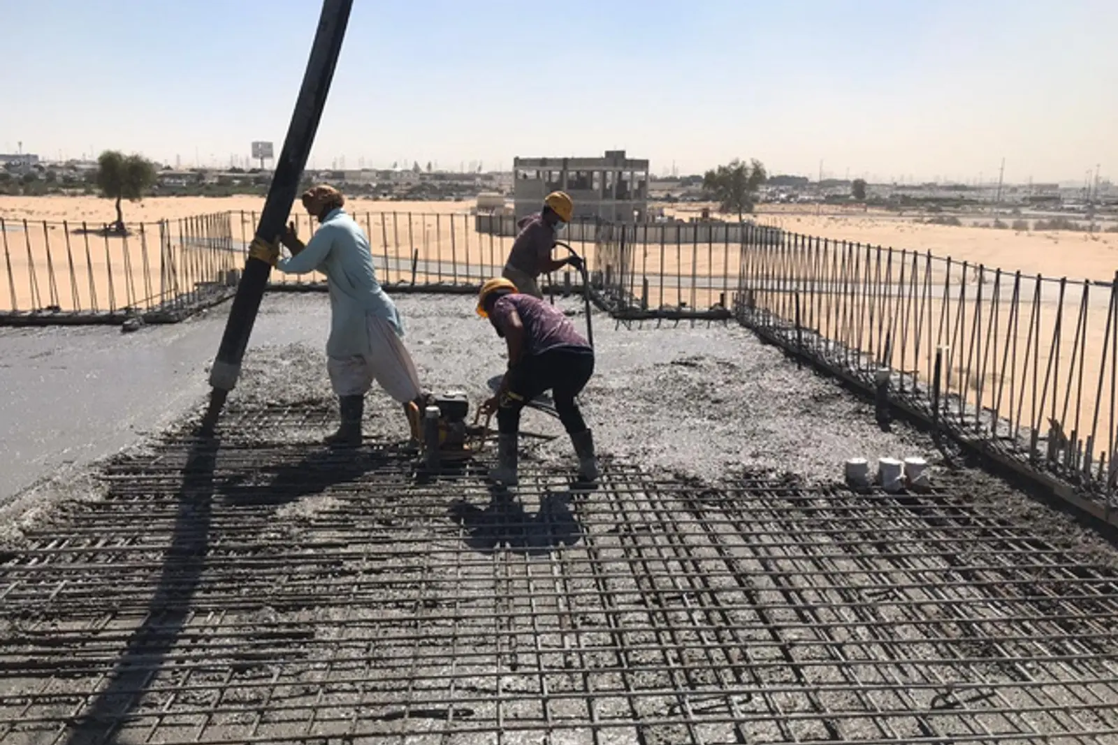 A Miles crew placing concrete to a reinforced slab